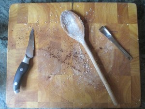 cutting board with spoons, knife