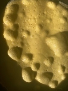 pancake bubbling in pan