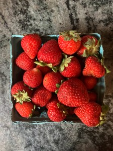 strawberries in quart container on counter