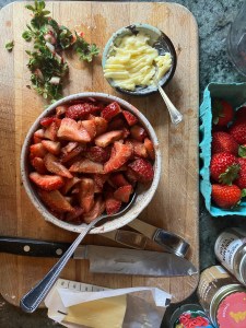 strawberries in bowl seasoned with cinnamon and ginger, butter in bowl whipped with rosewater
