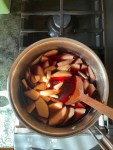 quinces and red wine in metal pot