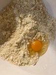 pastry ingredients -- flour butter sugar salt and egg -- in bowl