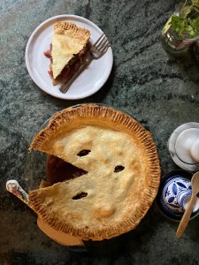 slice of quince pie on dish, cut whole quince pie