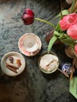 countertop with spices, cup, whipped cream, flowers