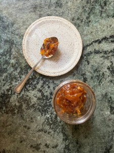 jar of jam, plate with spoon with jam