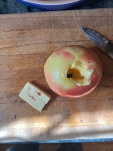 apple with butter on cutting board