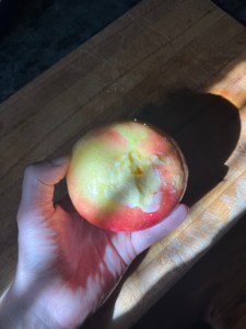 hand holding apple stuffed with butter and saffron